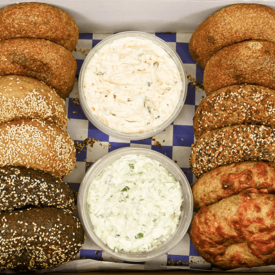 Two row of bagels with two varieties of cream cheese